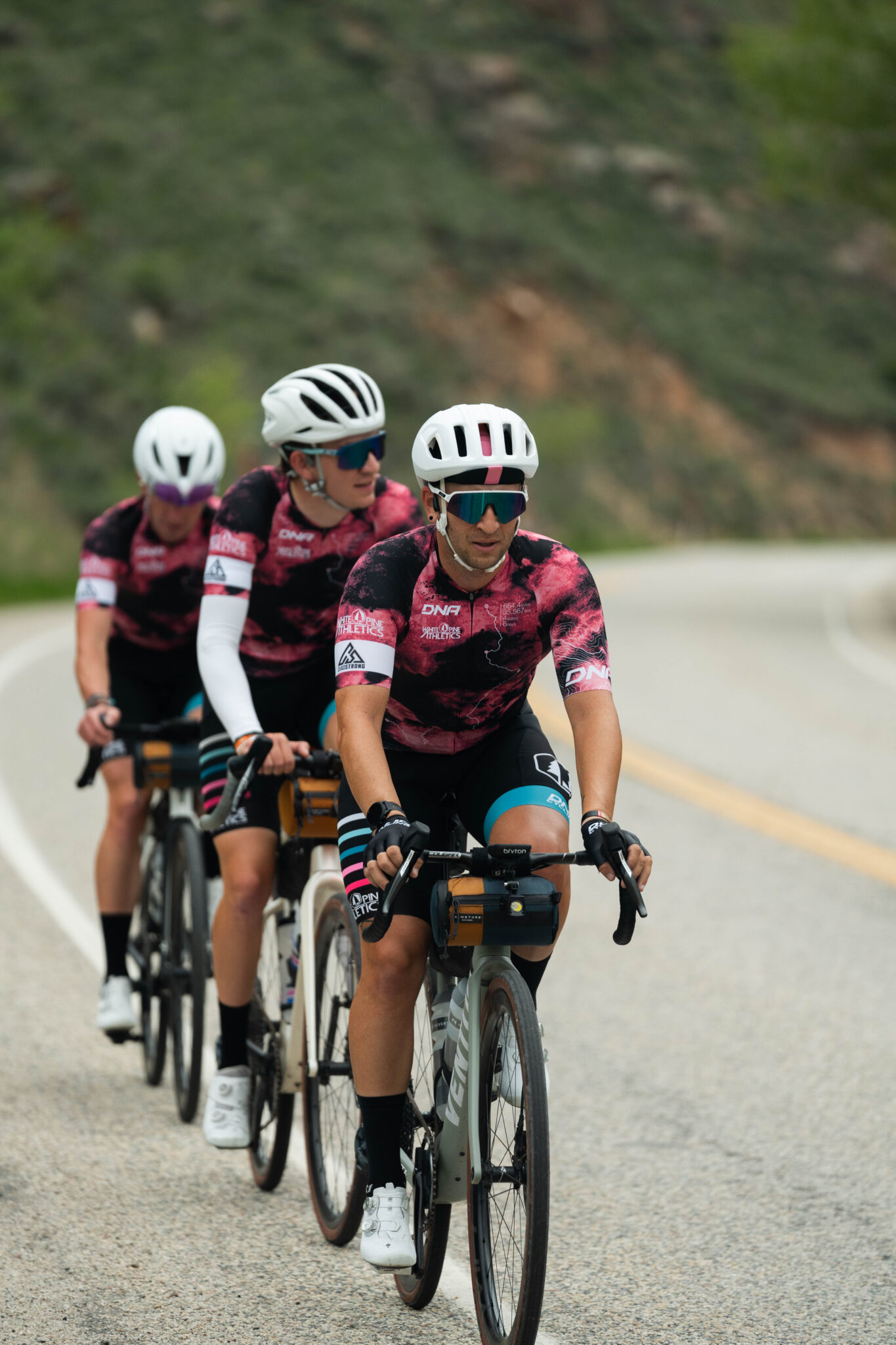 three people biking together