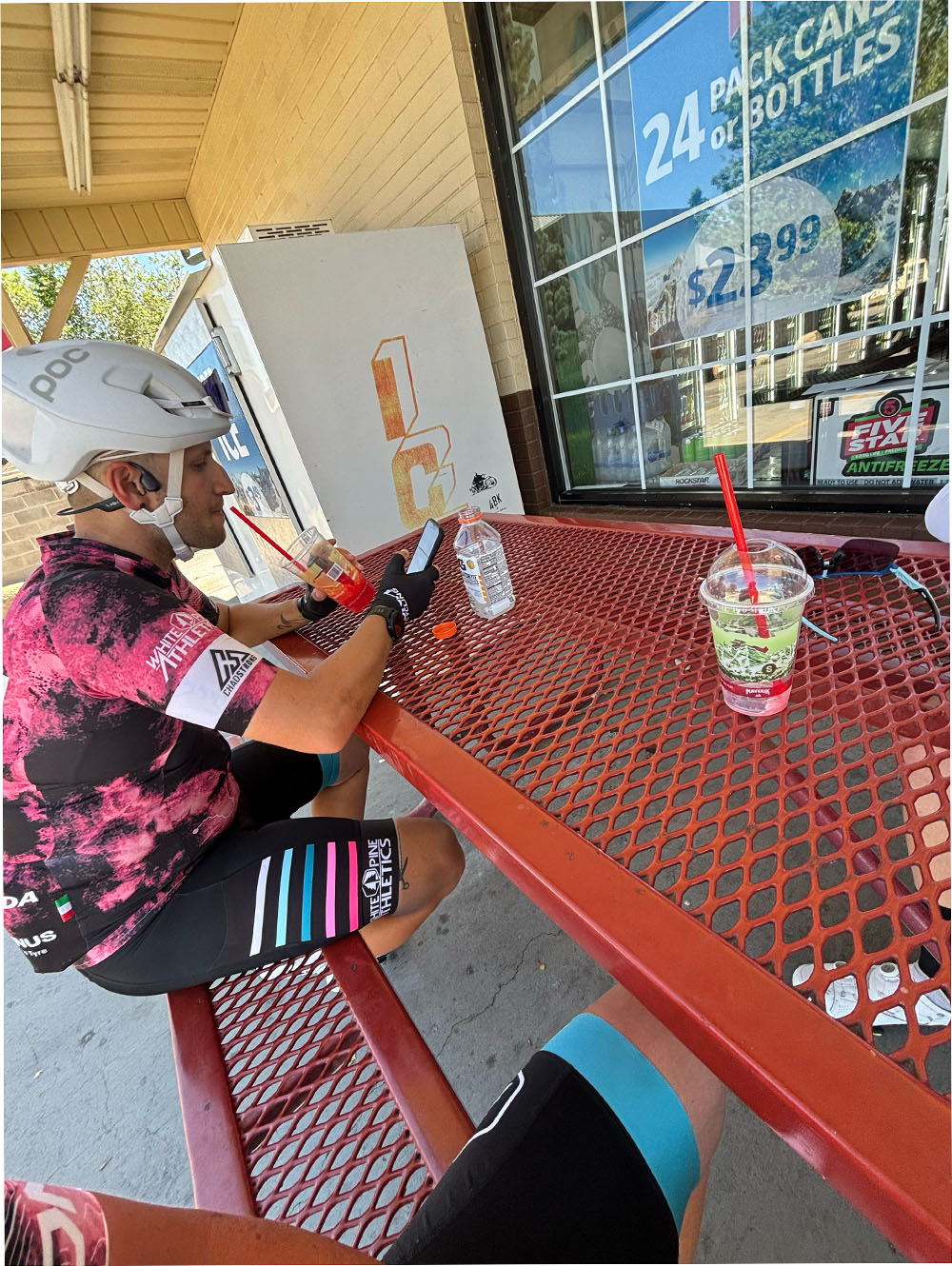 cyclist eating at gas station